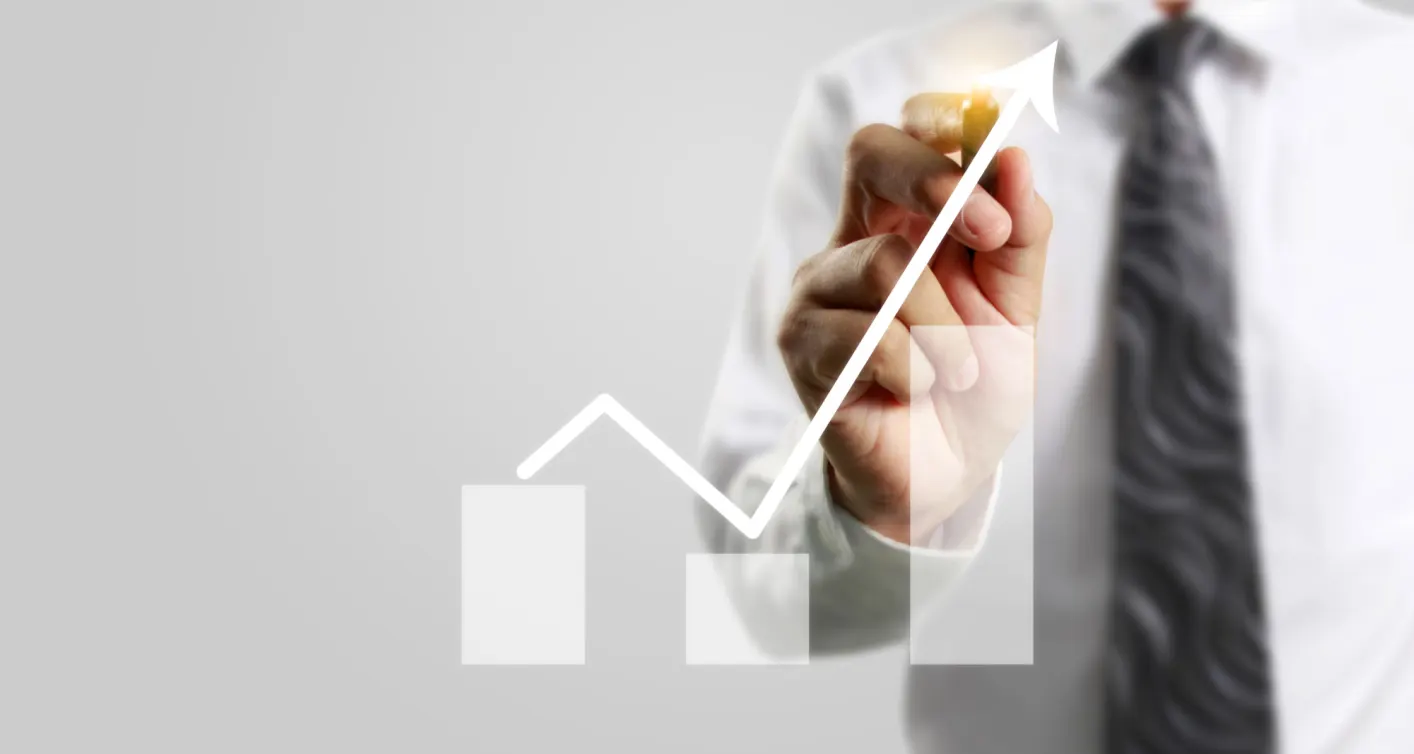 Hand drawing a rising growth arrow on a chart